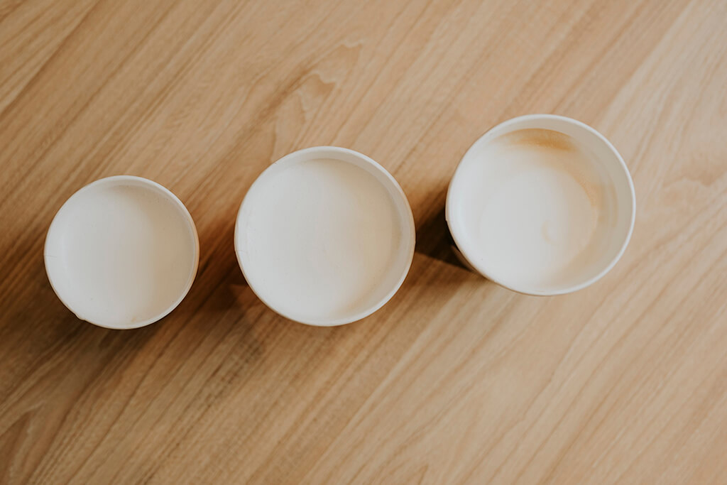 Three cups of cappuccino coffee.