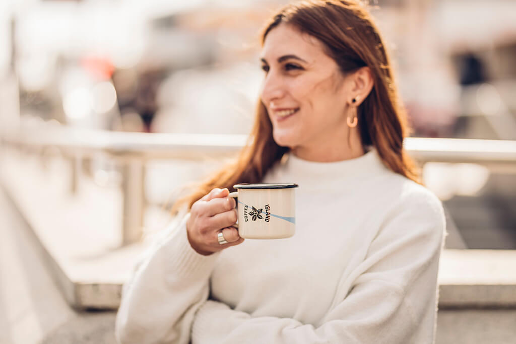 A woman enjoying her Coffee Island coffee.
