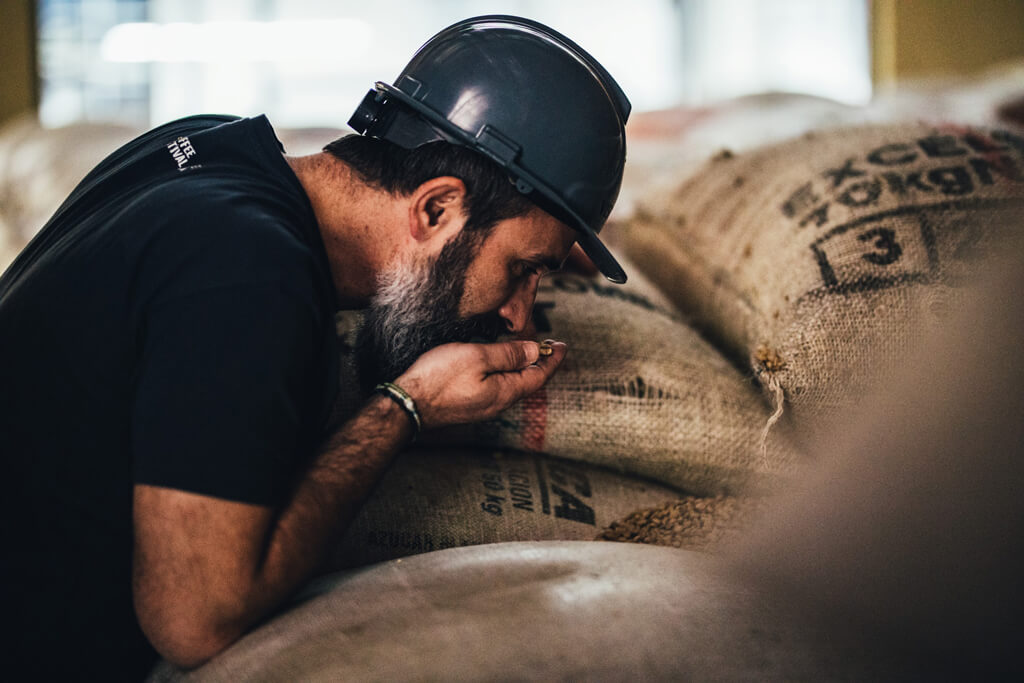 Coffee Island's coffee explorer, Pangagiotis Konstantinopoulos smelling coffee beans.