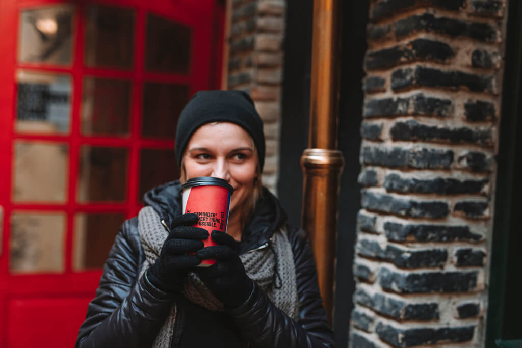 A woman enjoying her Coffee Island coffee.